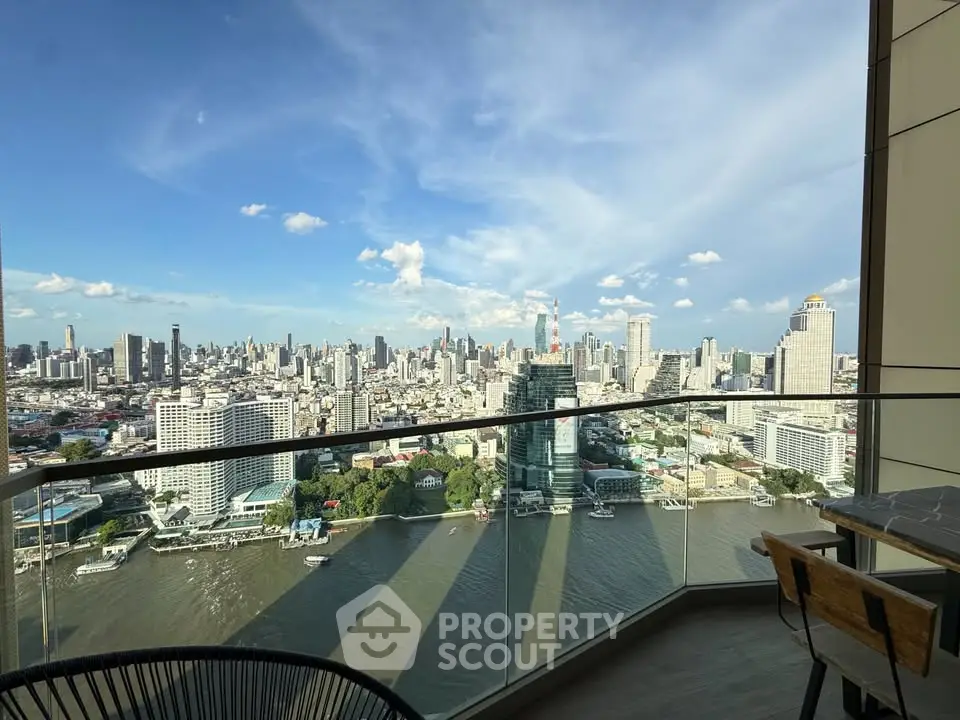 Stunning cityscape view from a high-rise balcony overlooking a river, perfect for urban living enthusiasts.