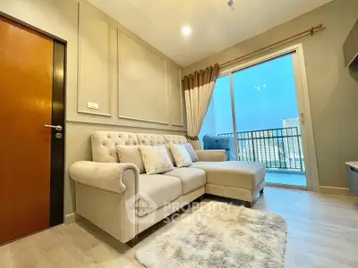 Modern living room with plush sofa and balcony view in a stylish apartment.