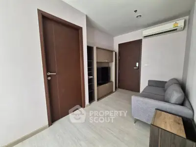 Modern living room with sleek furniture and air conditioning in a contemporary apartment.