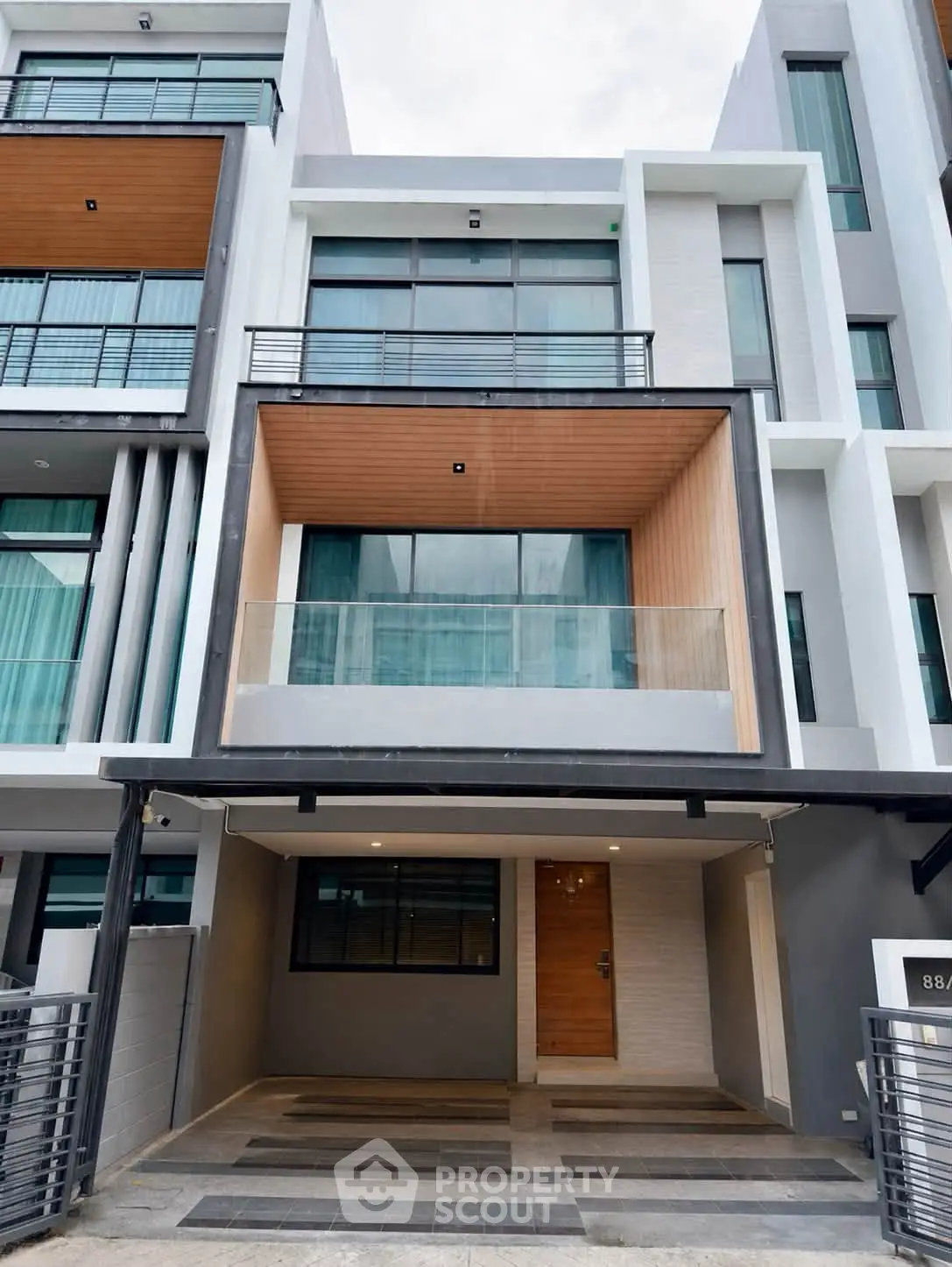 Modern townhouse exterior with sleek design and large windows, perfect for urban living.