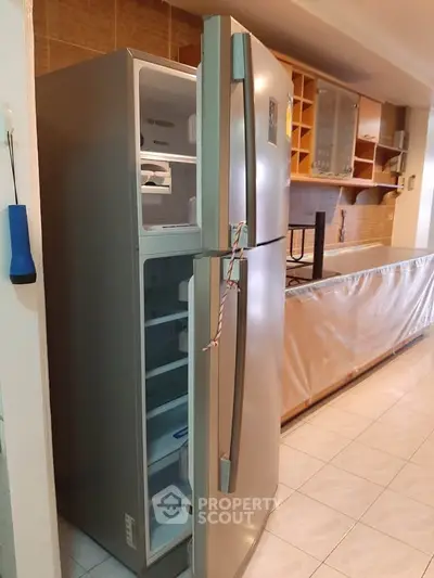 Spacious kitchen with modern fridge and ample storage space