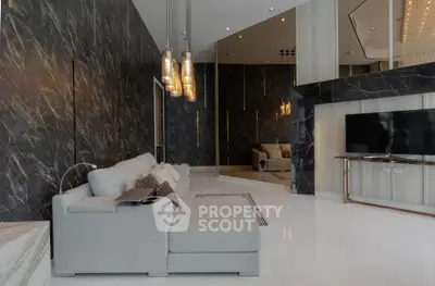 Luxurious modern living room with elegant marble walls and stylish lighting