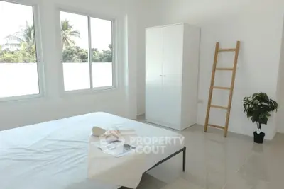 Bright minimalist bedroom with large windows and modern decor