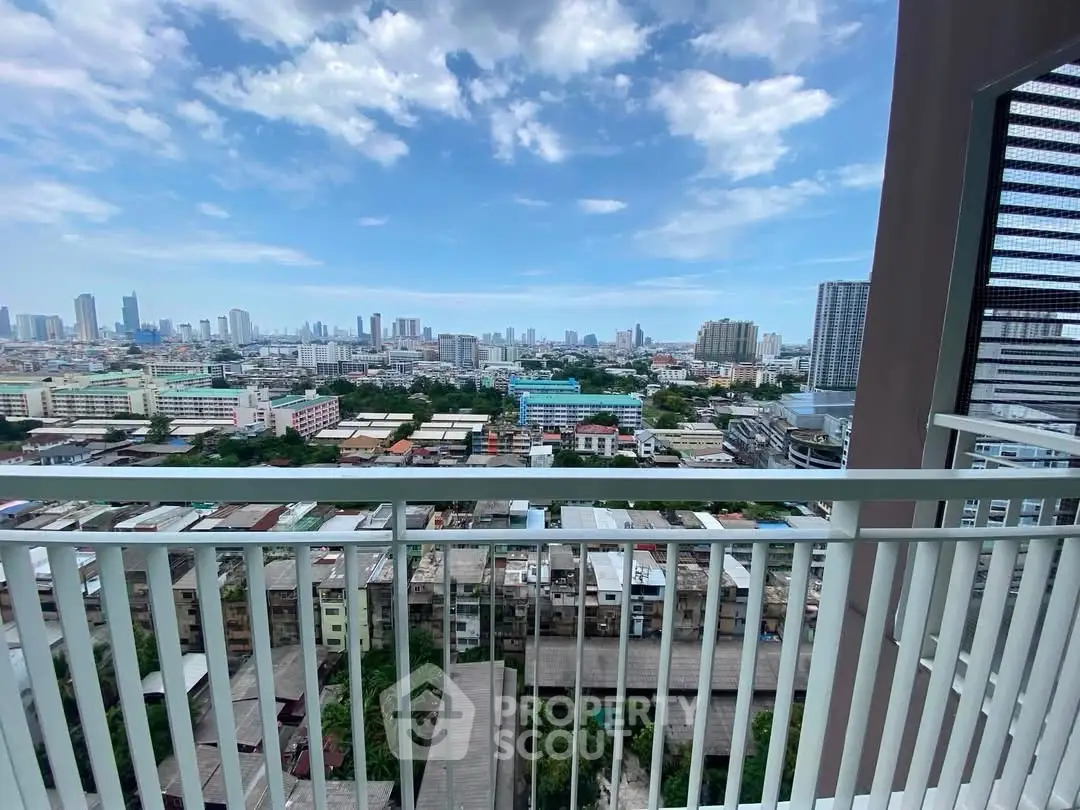 Stunning cityscape view from a high-rise balcony with clear blue skies.