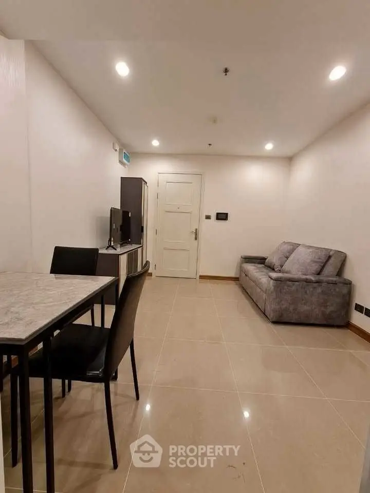 Modern living room with sleek furniture and tiled flooring, perfect for urban living.