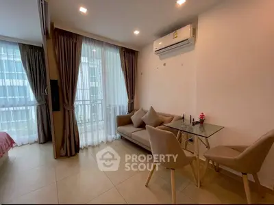 Modern living room with glass table and cozy sofa in bright apartment