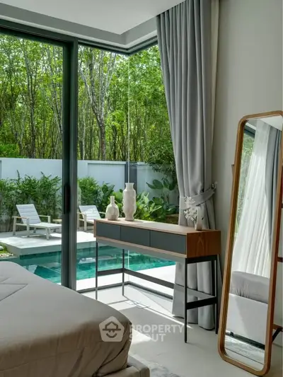 Luxurious bedroom with pool view and elegant decor, perfect for relaxation and comfort.