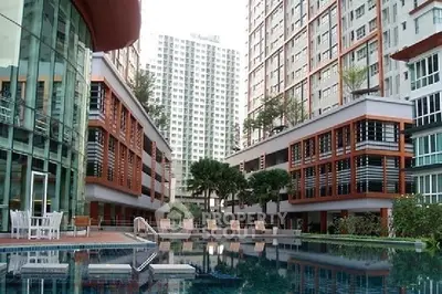 Luxurious apartment complex with modern architecture and inviting swimming pool area.