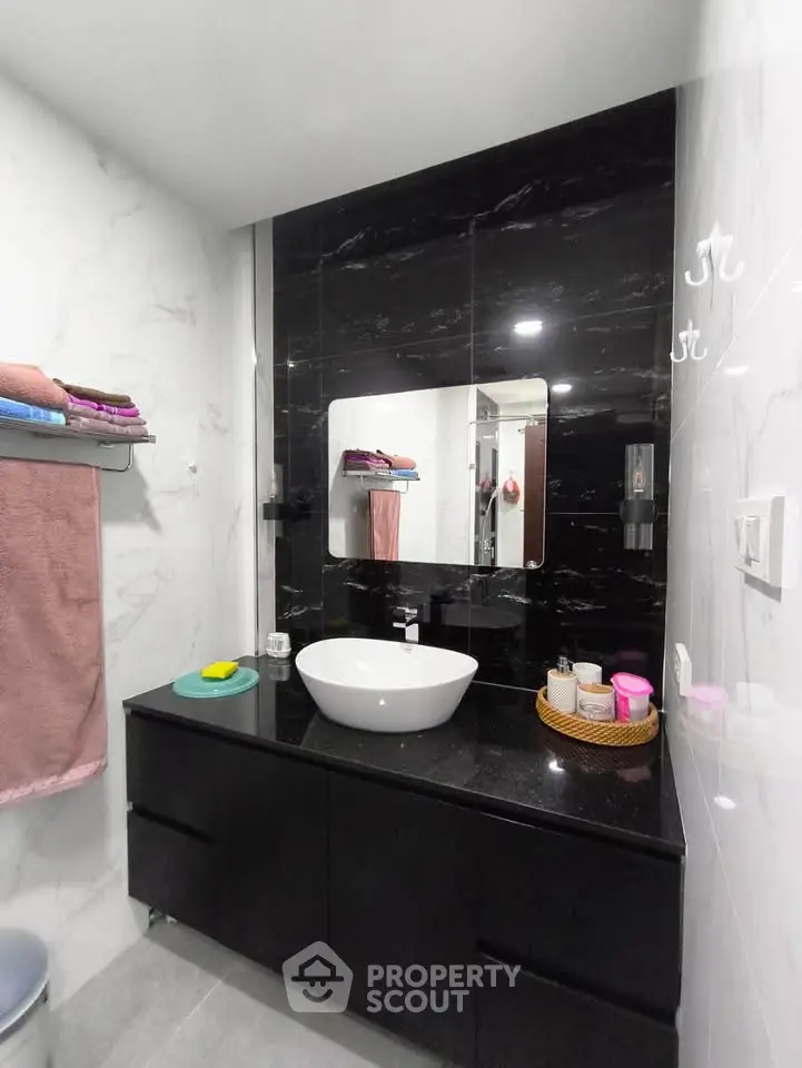 Modern bathroom with sleek black vanity and stylish mirror