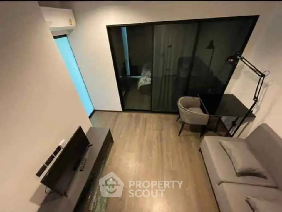 Modern living room with sleek furniture and large glass doors, perfect for urban living.