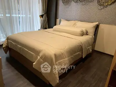 Luxurious bedroom with elegant decor and natural light, perfect for relaxation and comfort.