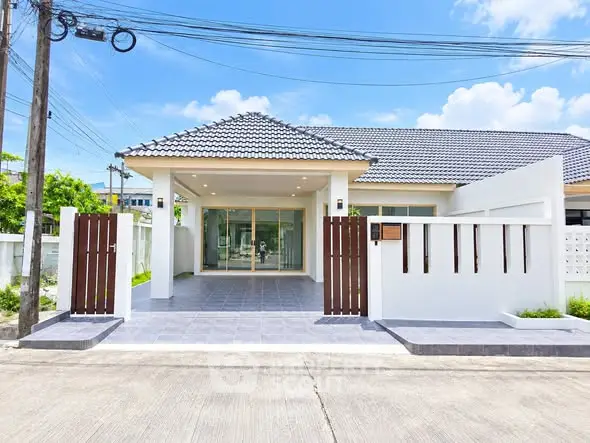 Charming modern house with tiled roof and spacious front patio in a serene neighborhood.