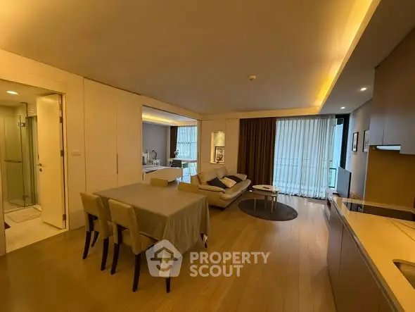 Modern open-plan living room with elegant dining area and cozy seating.