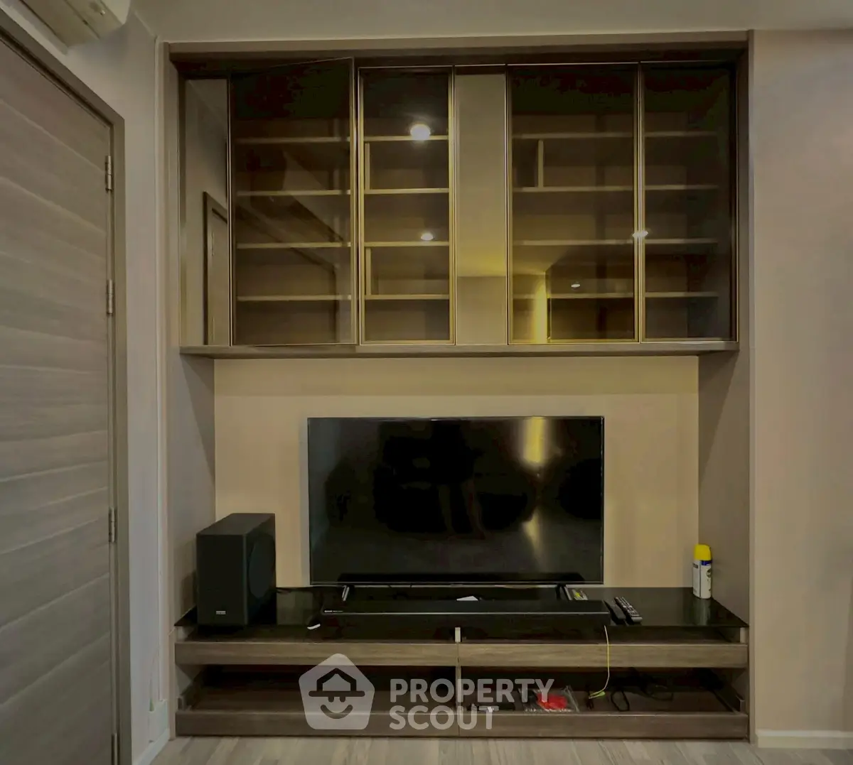Modern living room with sleek entertainment unit and built-in shelving