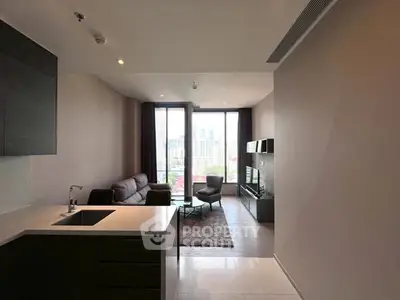 Modern open-plan living room with city view, sleek kitchen, and stylish furnishings.