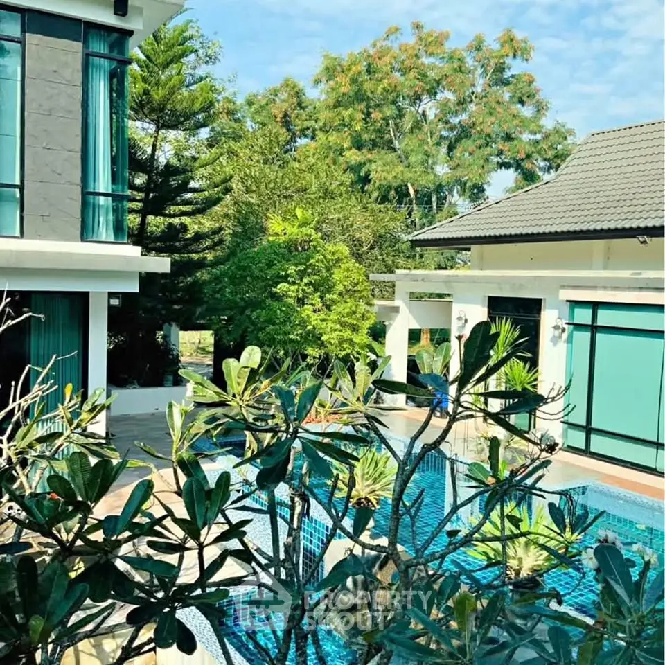 Luxurious modern home with private pool and lush greenery