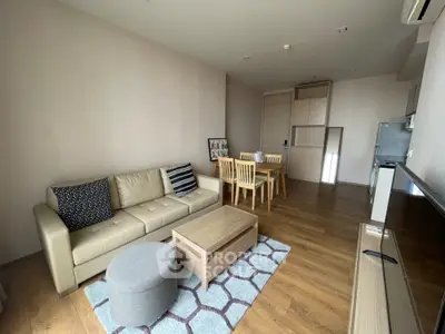 Modern living room with cozy sofa, dining area, and stylish decor in open layout apartment.