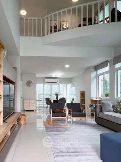 Spacious modern living room with high ceiling and stylish furniture