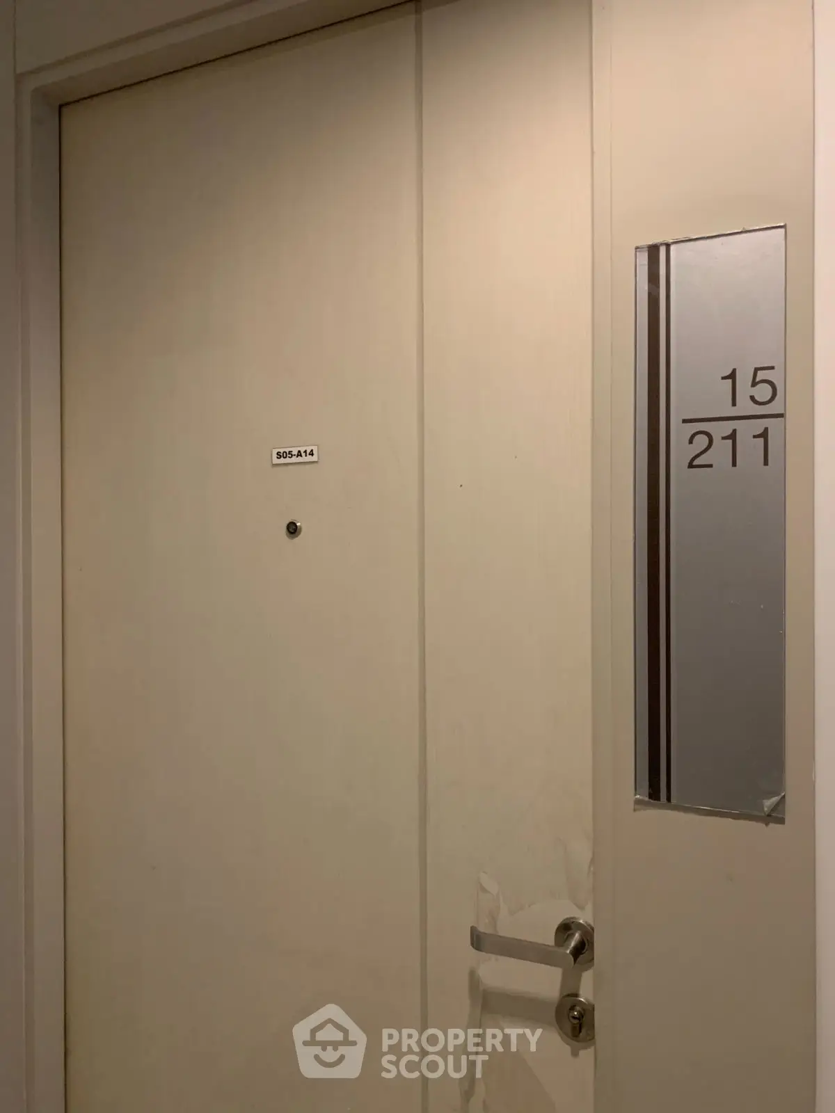 Modern apartment entrance with sleek door and room number signage.