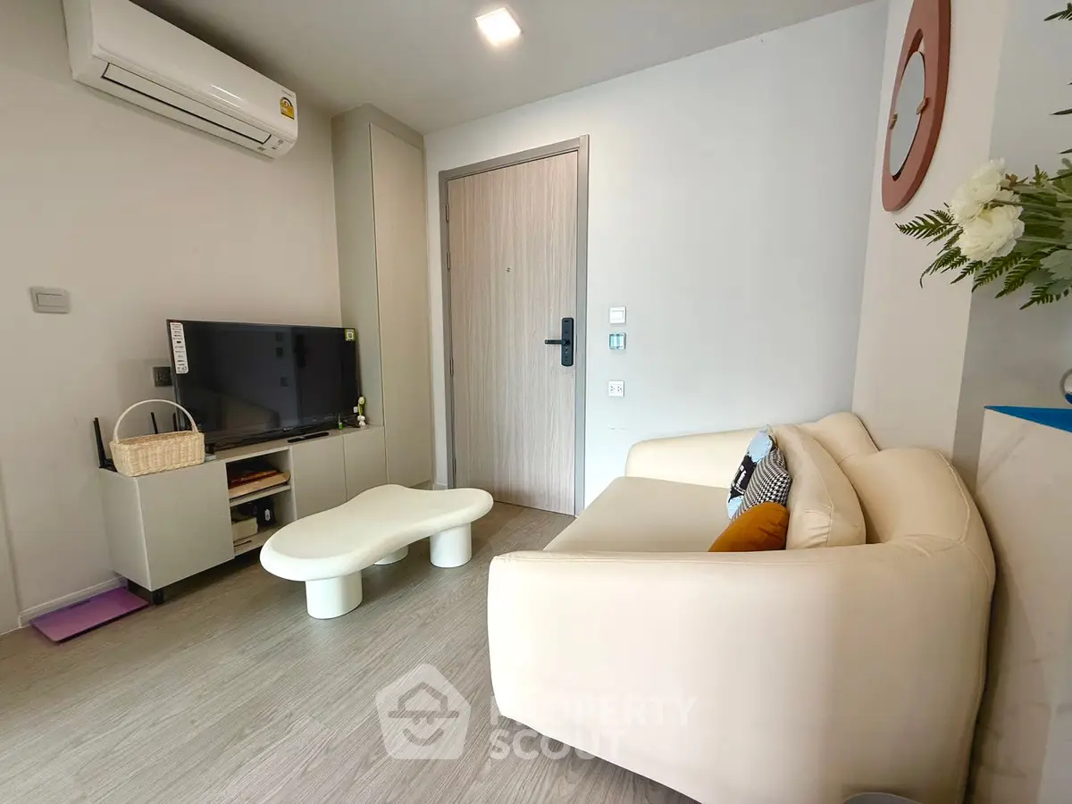 Cozy modern living room with stylish furniture and air conditioning