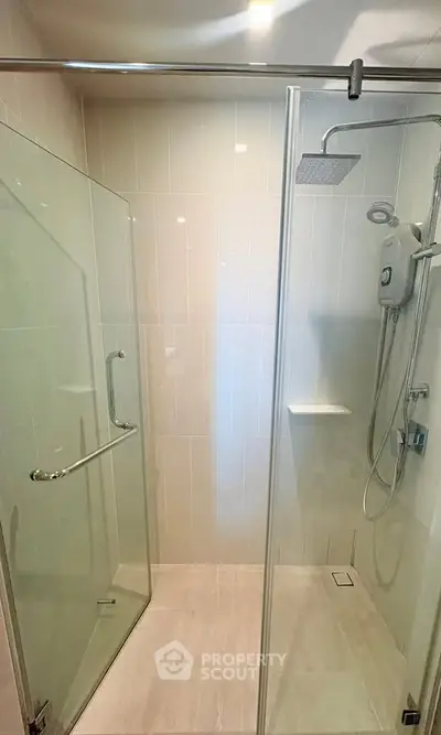 Modern bathroom with glass shower enclosure and rain showerhead