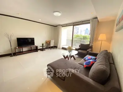 Spacious living room with modern furniture and large window offering a scenic view.