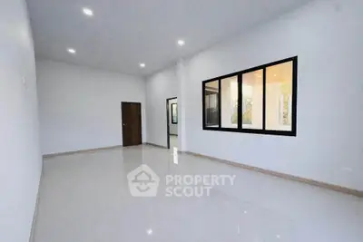 Spacious modern living room with large windows and sleek flooring