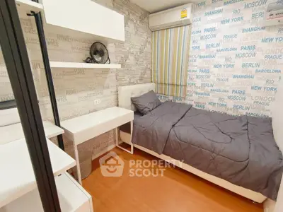 Cozy bedroom with modern decor and city-themed wallpaper, featuring a single bed and study desk.