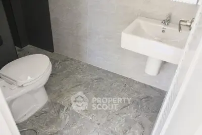 Modern bathroom with sleek gray tiles and contemporary fixtures