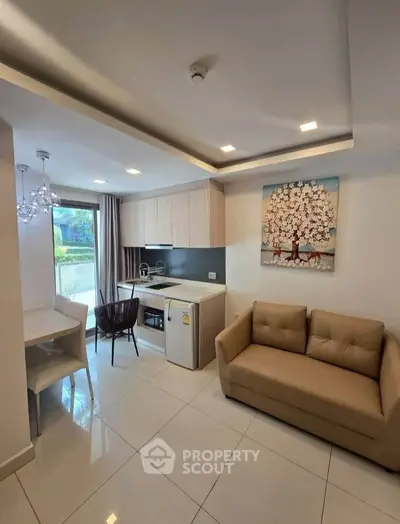 Modern open-layout kitchen and living area with stylish decor and natural light.