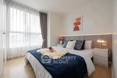 Modern bedroom with stylish decor and large window for natural light