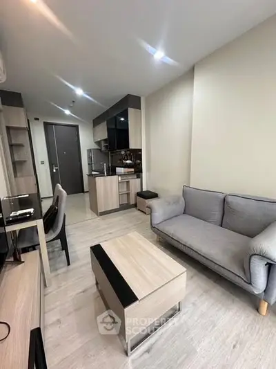 Modern living room with sleek furniture and open kitchen layout