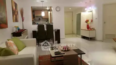 Modern living room with open kitchen, stylish decor, and cozy ambiance in a contemporary apartment.