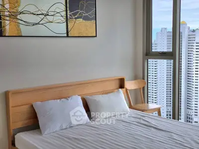 Modern bedroom with city view, featuring a stylish wooden bed and contemporary artwork.