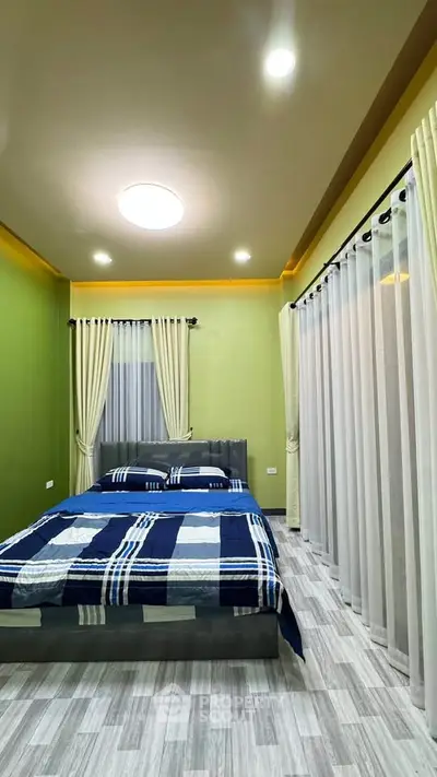 Modern bedroom with stylish decor and ample natural light