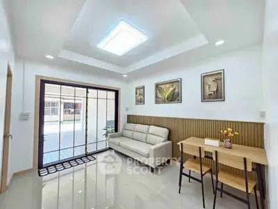 Modern living room with sleek furniture and large glass doors opening to a patio, perfect for relaxation.