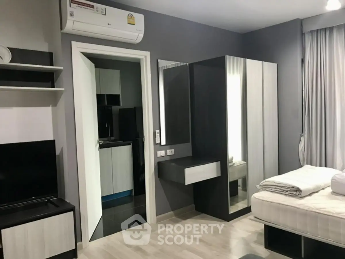 Modern bedroom with sleek furniture and air conditioning in a stylish apartment.