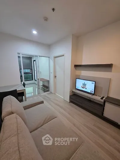 Modern living room with cozy sofa and TV, open layout design