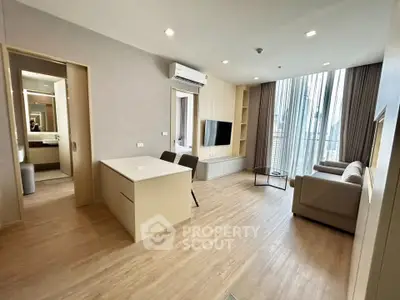 Modern living room with open layout and stylish furniture in a high-rise apartment.