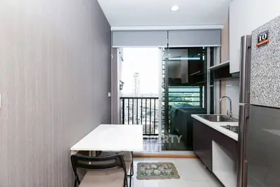 Modern kitchen with balcony view in high-rise apartment