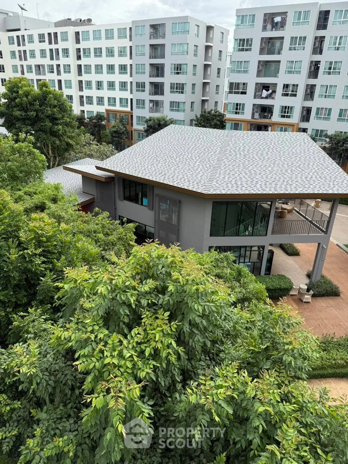 Modern residential building with lush greenery and spacious balcony