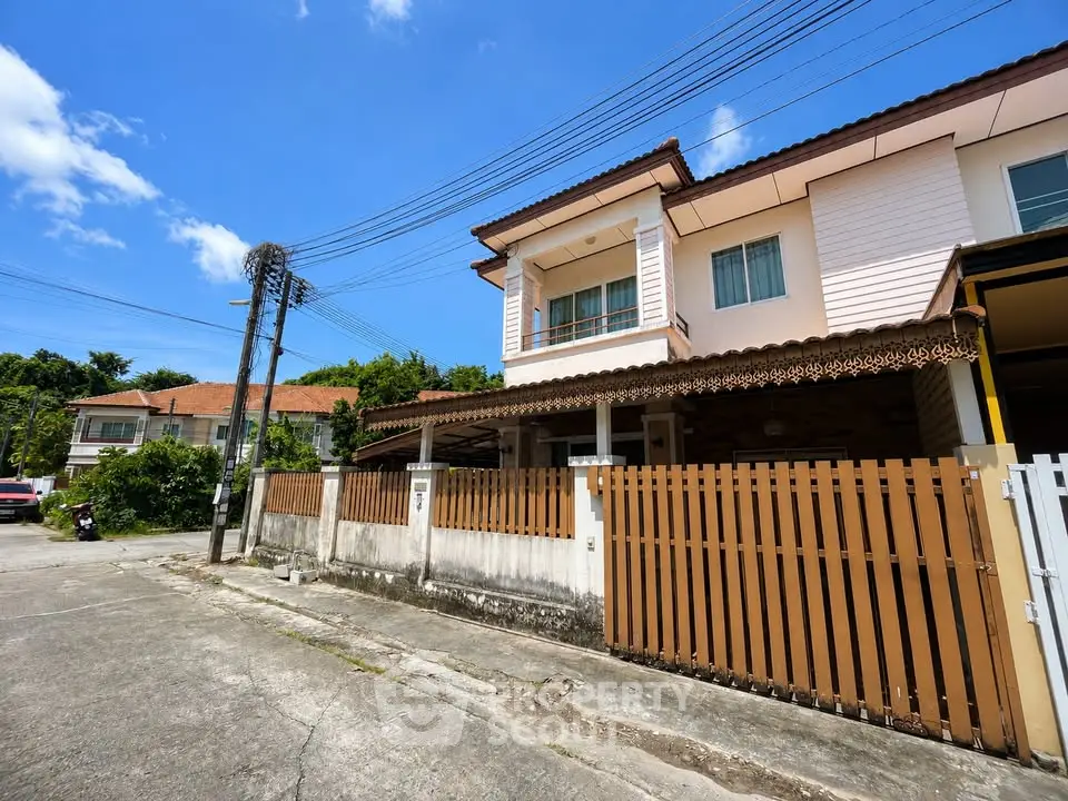 Charming two-story house with a fenced yard in a serene neighborhood.
