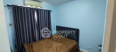 Cozy bedroom with modern decor and air conditioning in a stylish apartment.
