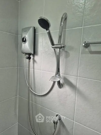 Modern bathroom shower with sleek chrome fixtures and tiled walls.