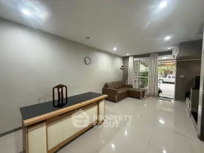 Spacious living room with modern decor and large windows for natural light.