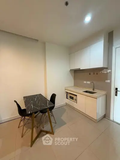 Modern minimalist kitchen with sleek cabinetry and dining area