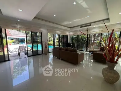 Luxurious living room with pool view and modern decor in a spacious villa