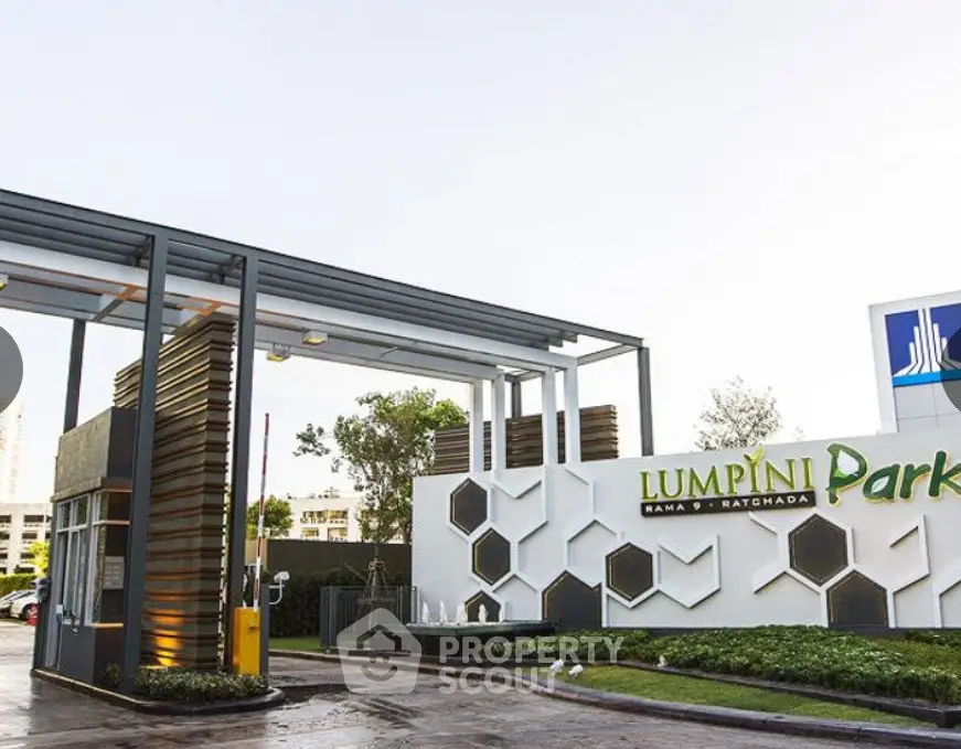 Modern entrance of Lumpini Park Rama 9 Ratchada with sleek design and lush greenery.