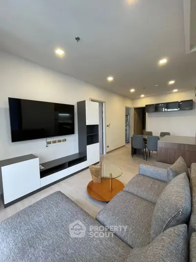 Modern living room with sleek furniture and open kitchen layout