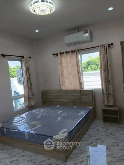 Spacious bedroom with large windows and modern decor